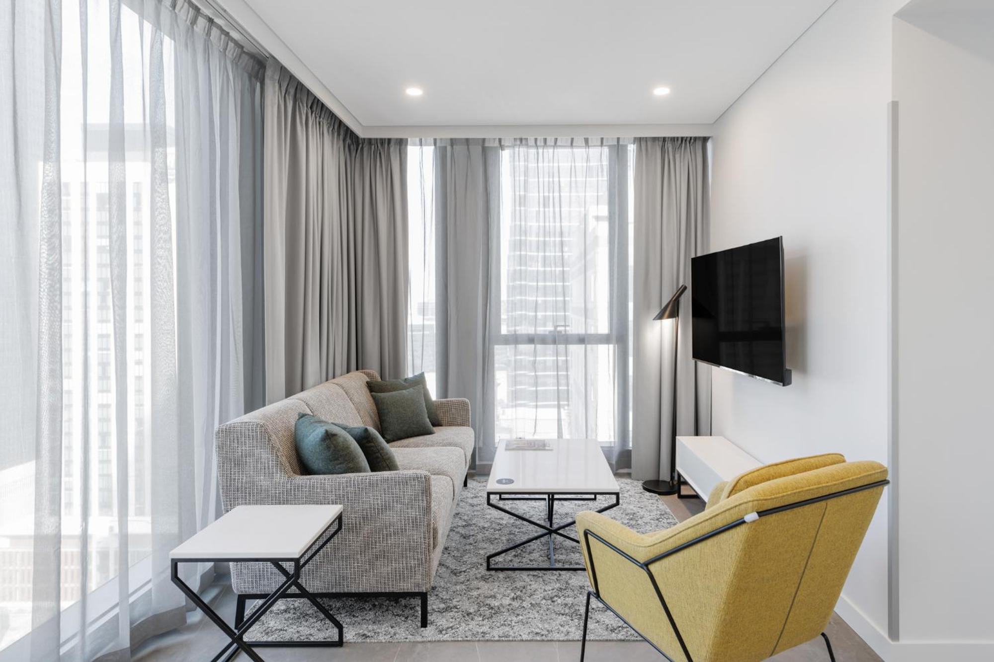 Meriton Suites Melburne Exterior foto A living room in a typical apartment